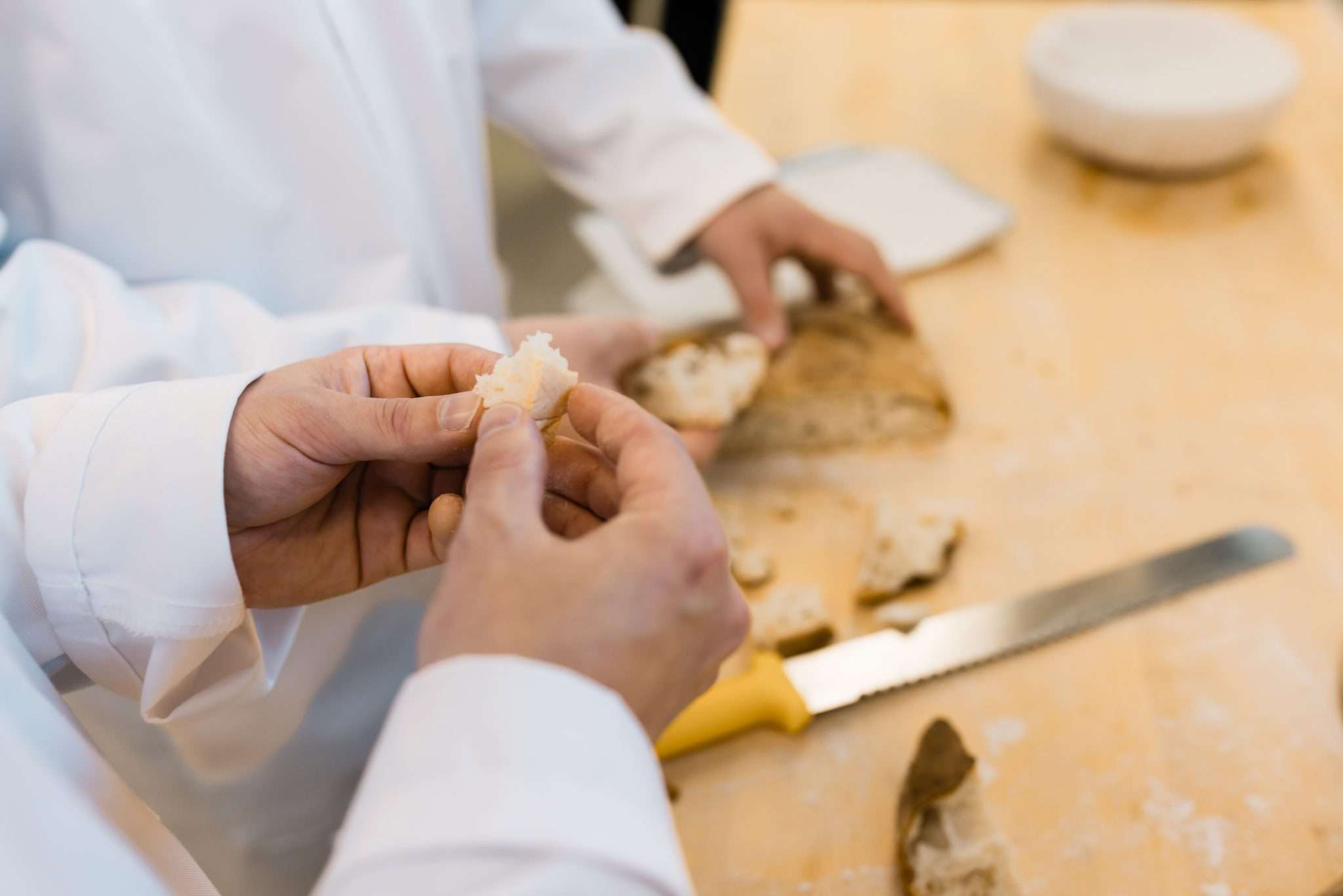 Bakers analyzing bread baked in test bakery
