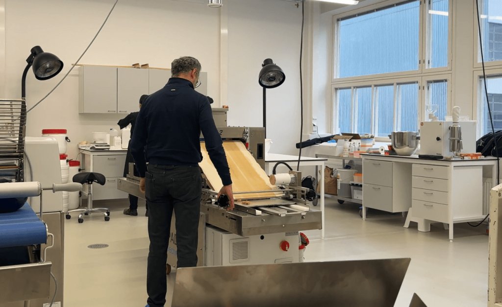 A person operating a rotary moulder at Baron Foodtech’s Innovation Center during a product test session.